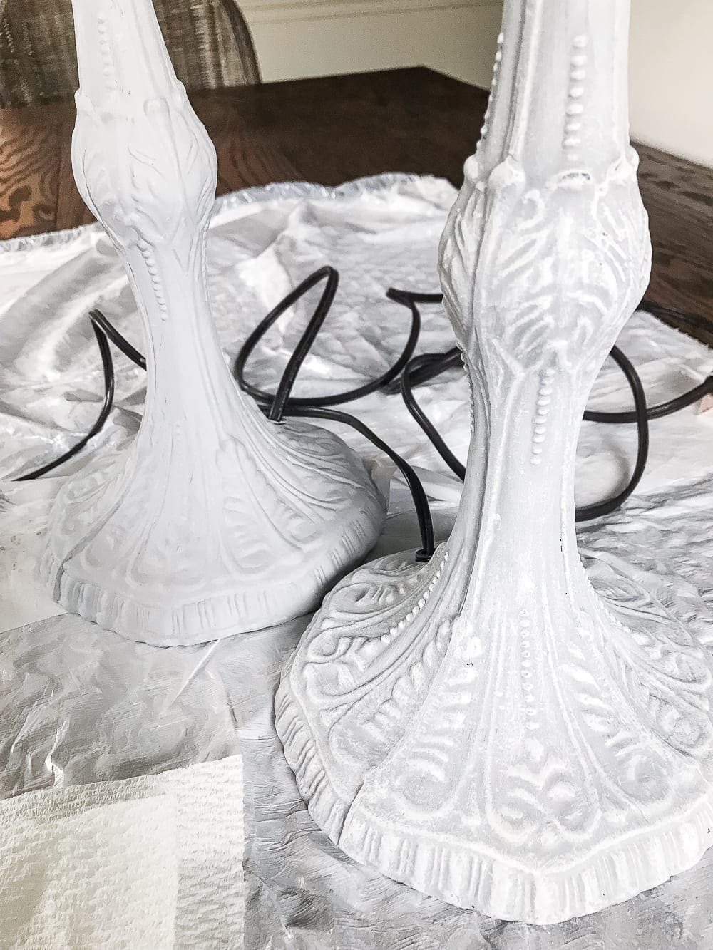 A thrifted table lamp gets a French Baroque designer inspired makeover using Annie Sloan Chalk Paint in Paris Grey, Pure White, clear wax, and dark wax. #thriftdecor #thrifted #thrifting #thriftmakeover #lamp #bedroom #girlbedroom #littlegirlbedroom #frenchdecor #femininedecor #designerknockoff #designerdecor