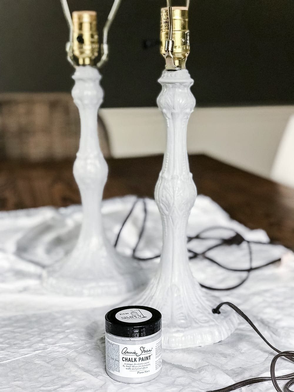 A thrifted table lamp gets a French Baroque designer inspired makeover using Annie Sloan Chalk Paint in Paris Grey, Pure White, clear wax, and dark wax. #thriftdecor #thrifted #thrifting #thriftmakeover #lamp #bedroom #girlbedroom #littlegirlbedroom #frenchdecor #femininedecor #designerknockoff #designerdecor