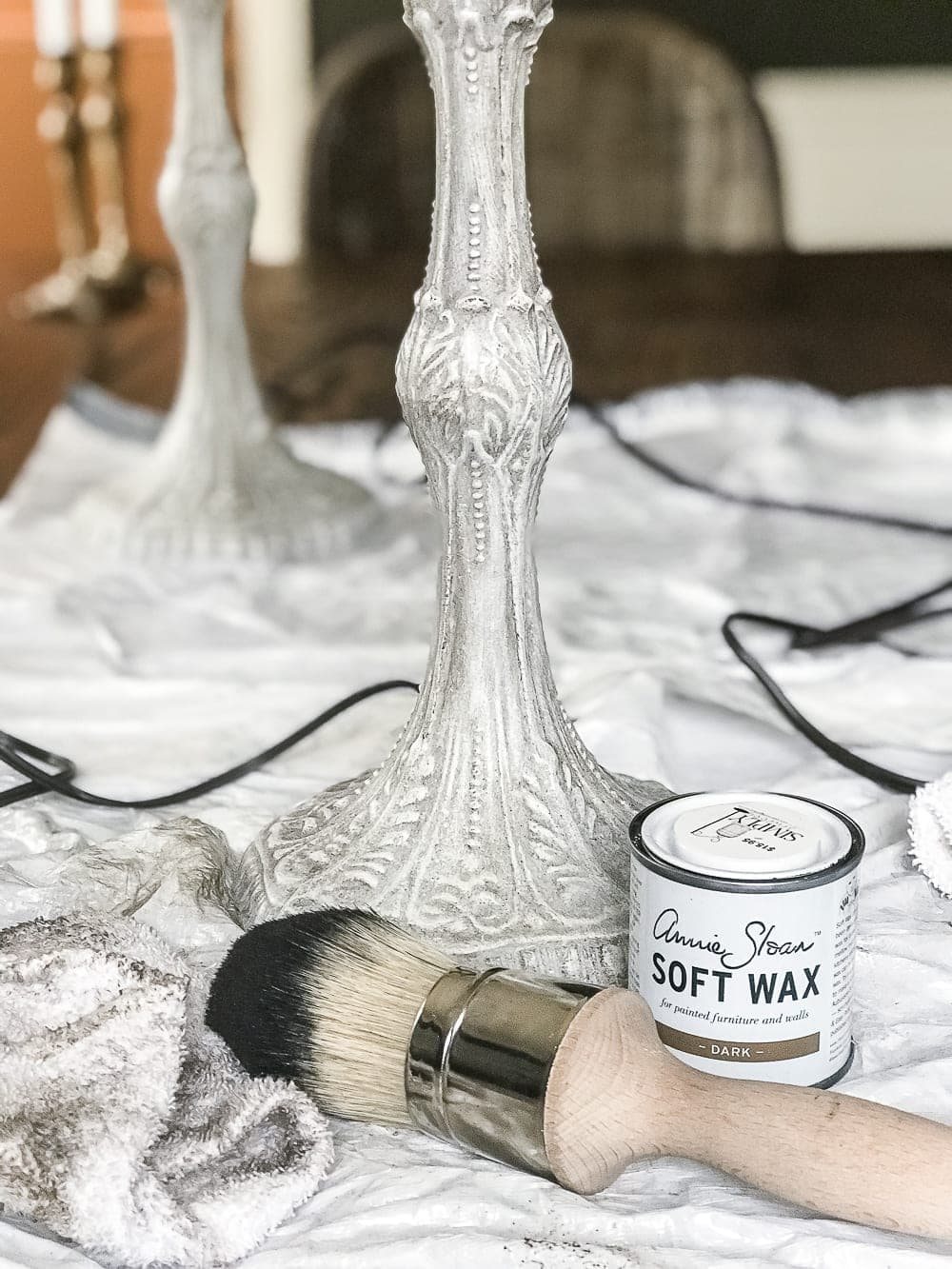 A thrifted table lamp gets a French Baroque designer inspired makeover using Annie Sloan Chalk Paint in Paris Grey, Pure White, clear wax, and dark wax. #thriftdecor #thrifted #thrifting #thriftmakeover #lamp #bedroom #girlbedroom #littlegirlbedroom #frenchdecor #femininedecor #designerknockoff #designerdecor