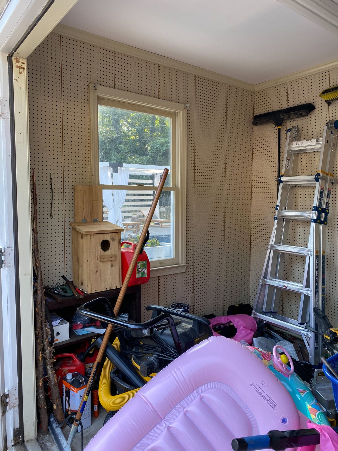 backyard shed before with beige pegboard
