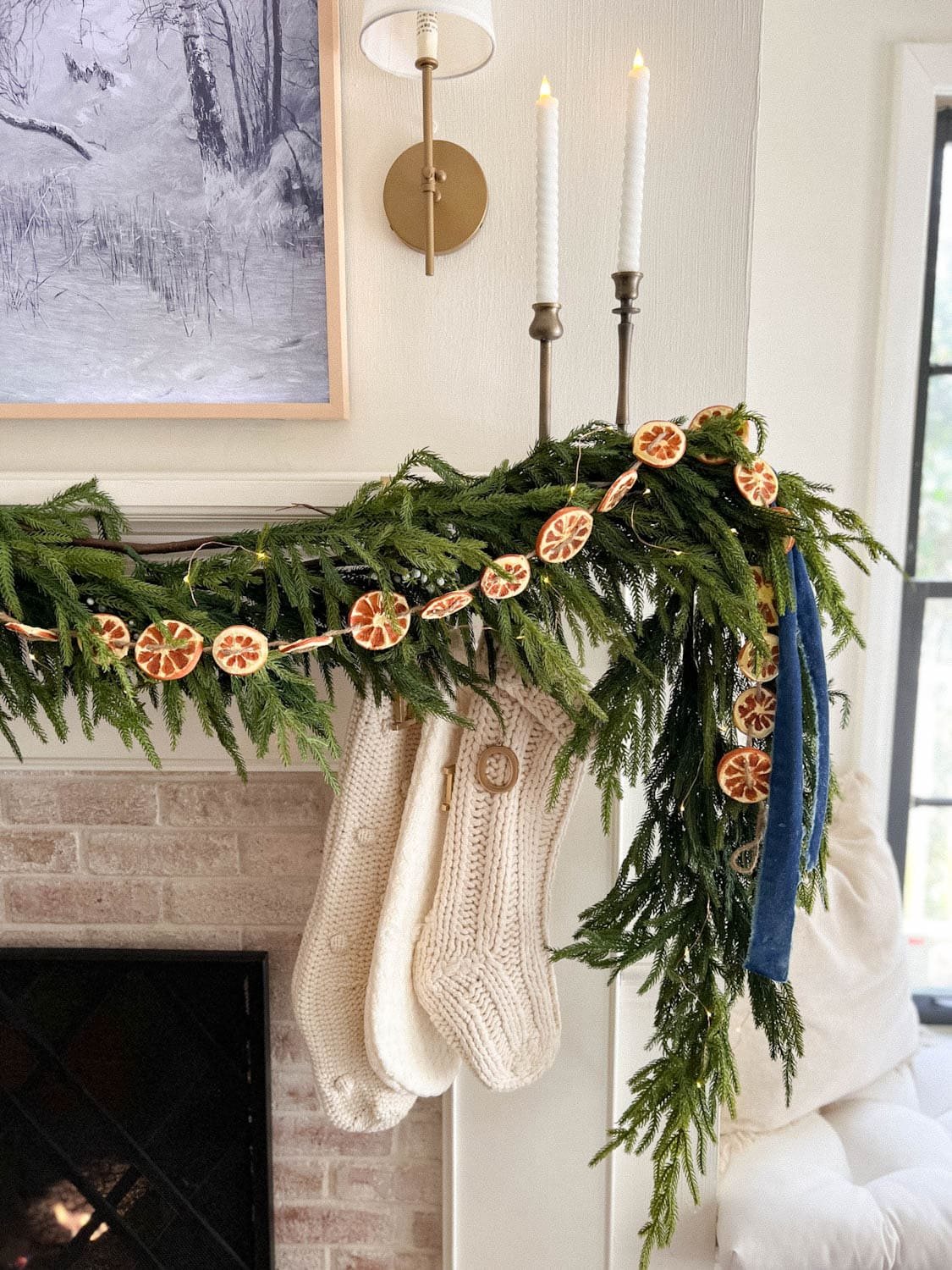mantel garland with battery operated Christmas lights and battery operated wax candles