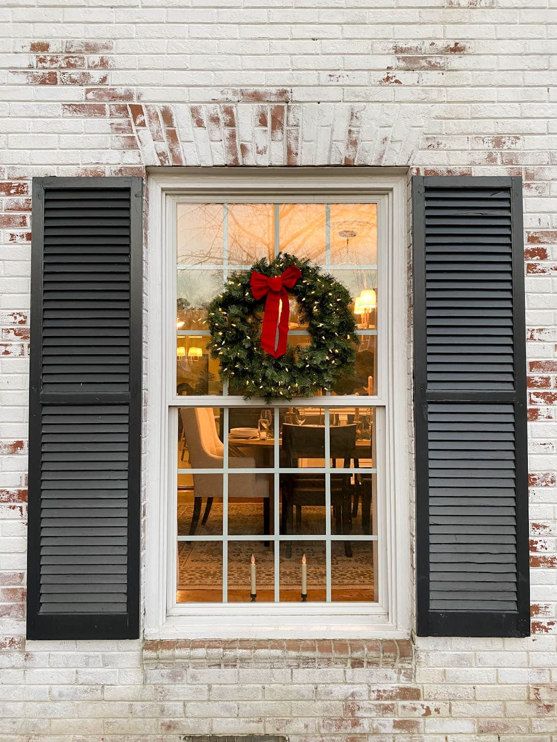 pre-lit Christmas wreath on exterior window