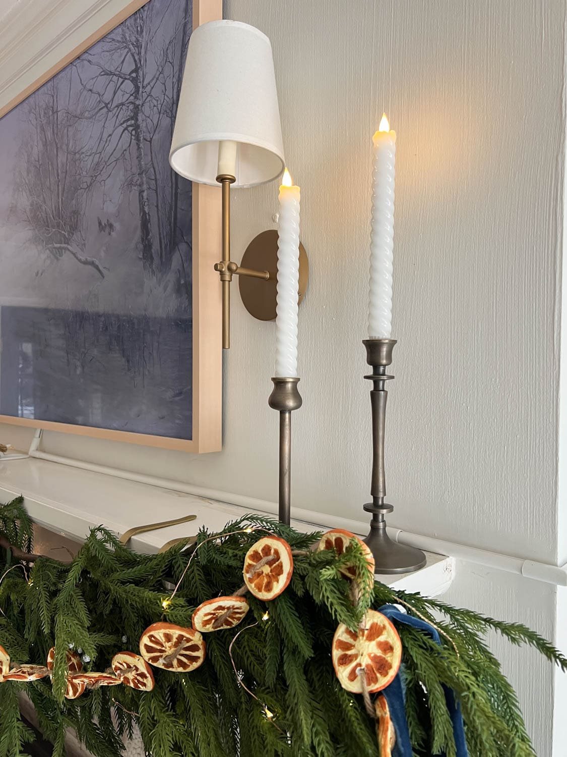 wax battery operated candles on a Christmas mantel