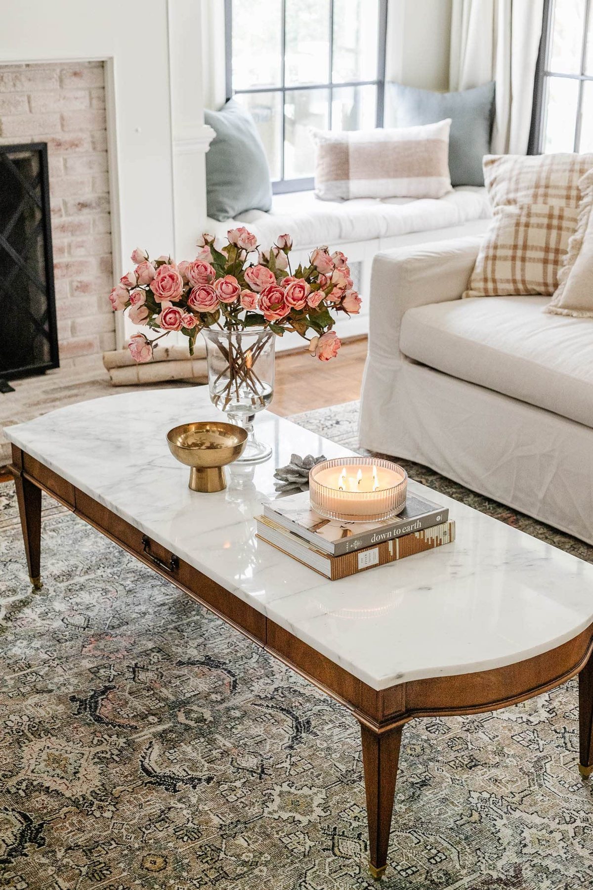 vintage marble coffee table with vase of pink roses