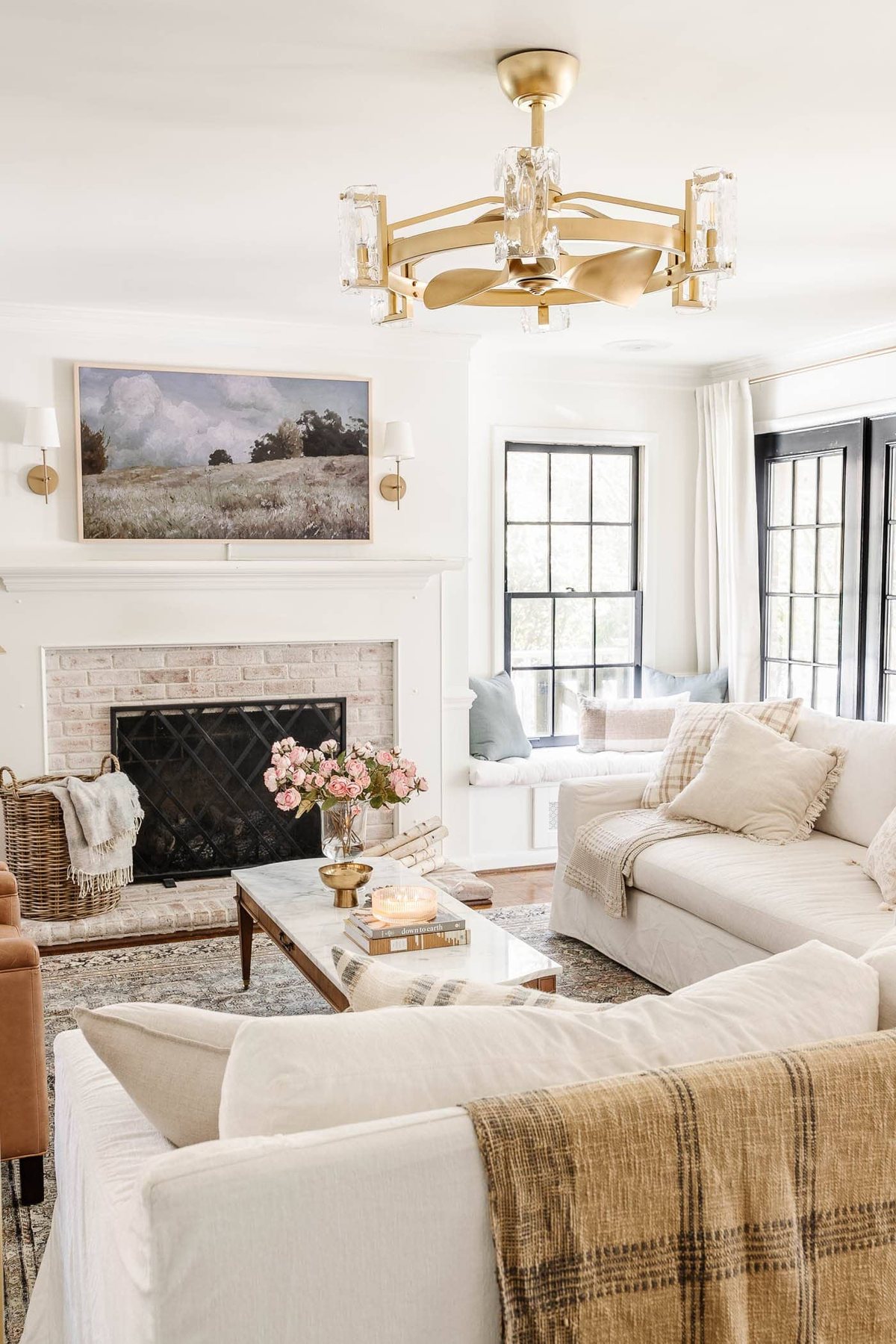 limewashed fireplace in an all white living room with spring decor