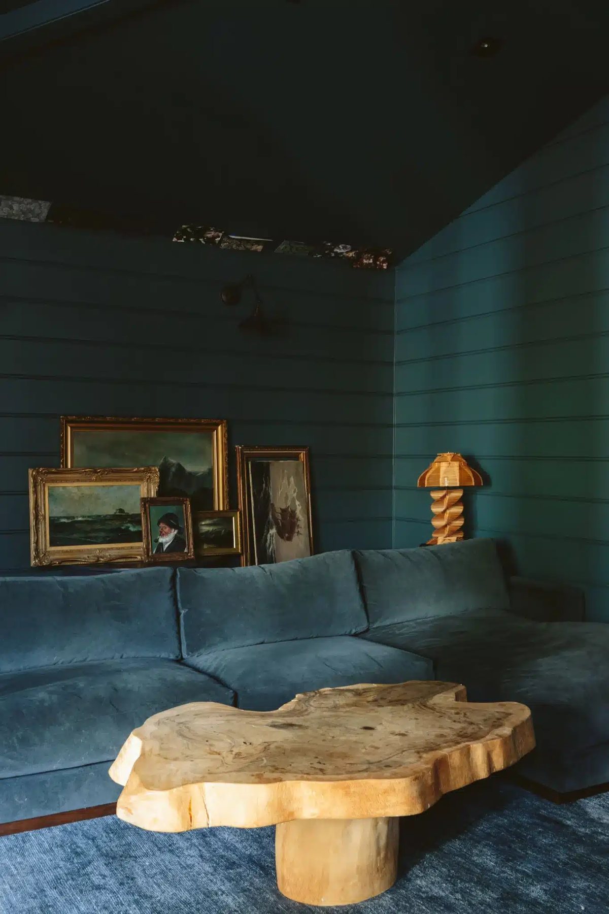 sherwin williams still water dark teal on shiplap wall in a family room