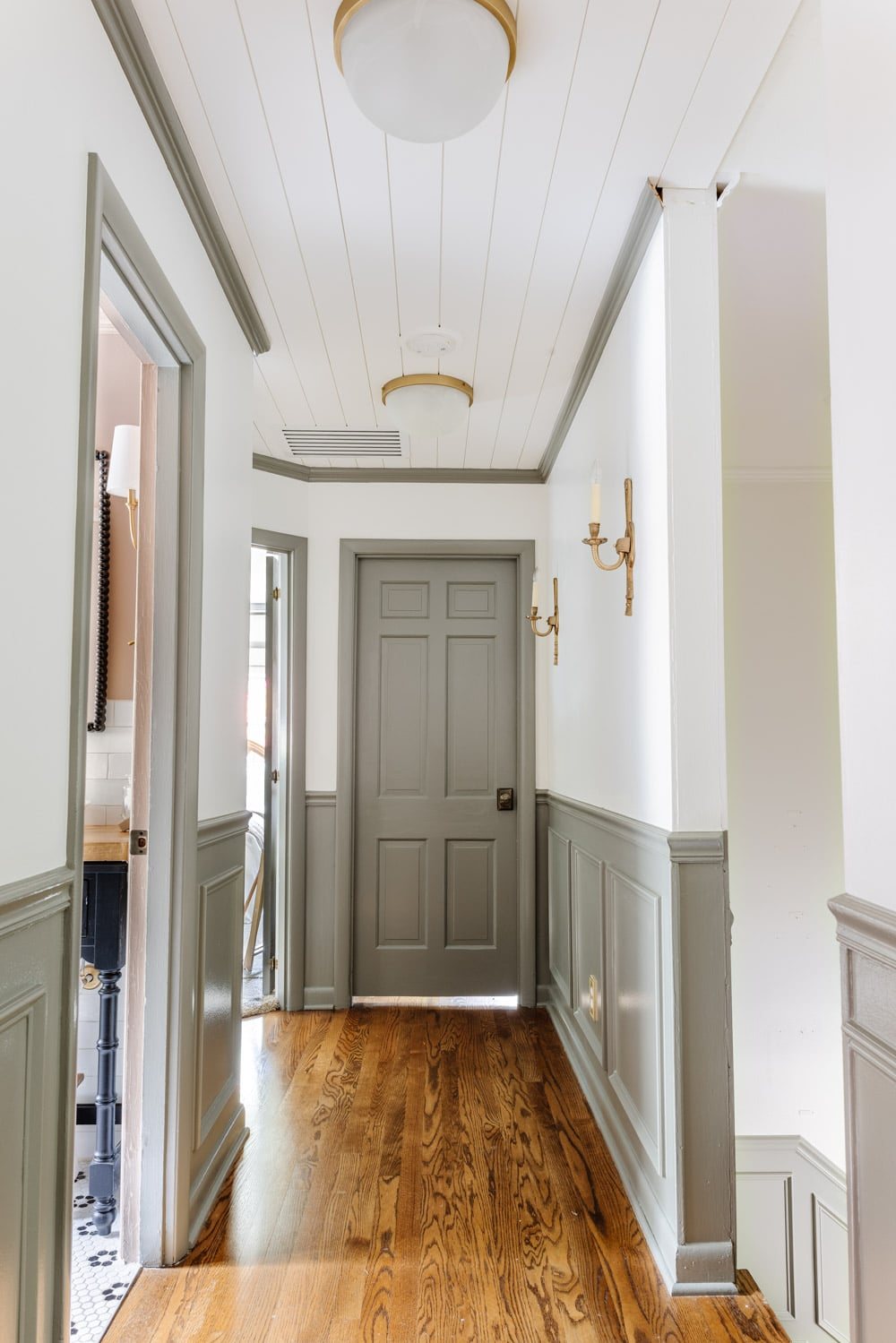painted doors and wainscoting in a hallway with Sherwin Williams Willowleaf