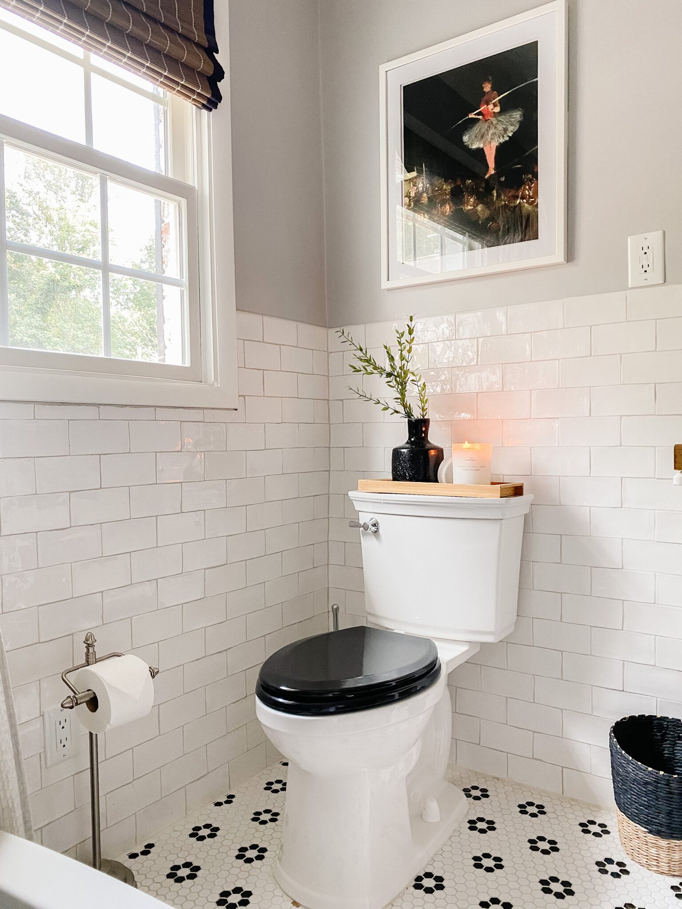 retro bathroom with black and white tile and black toilet seat