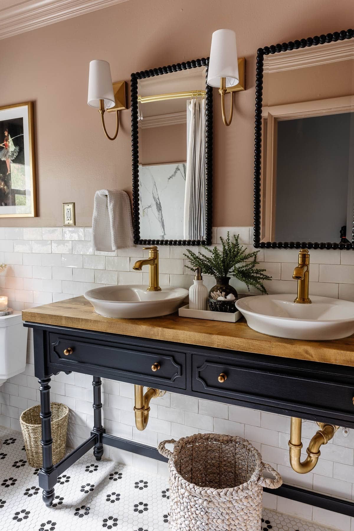 black and pink bathroom with console table vanity and vessel sinks