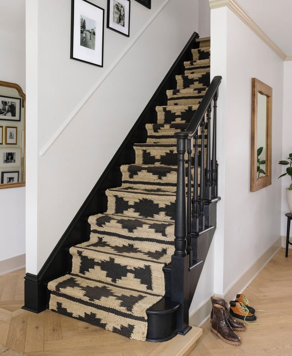 painted black stairs with geometric jute rug