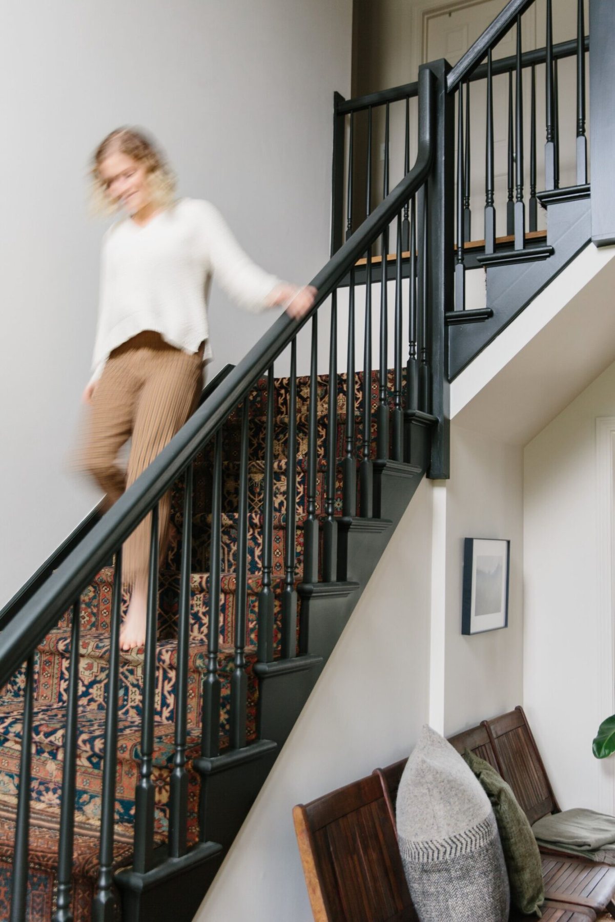 black painted staircase with vintage rug