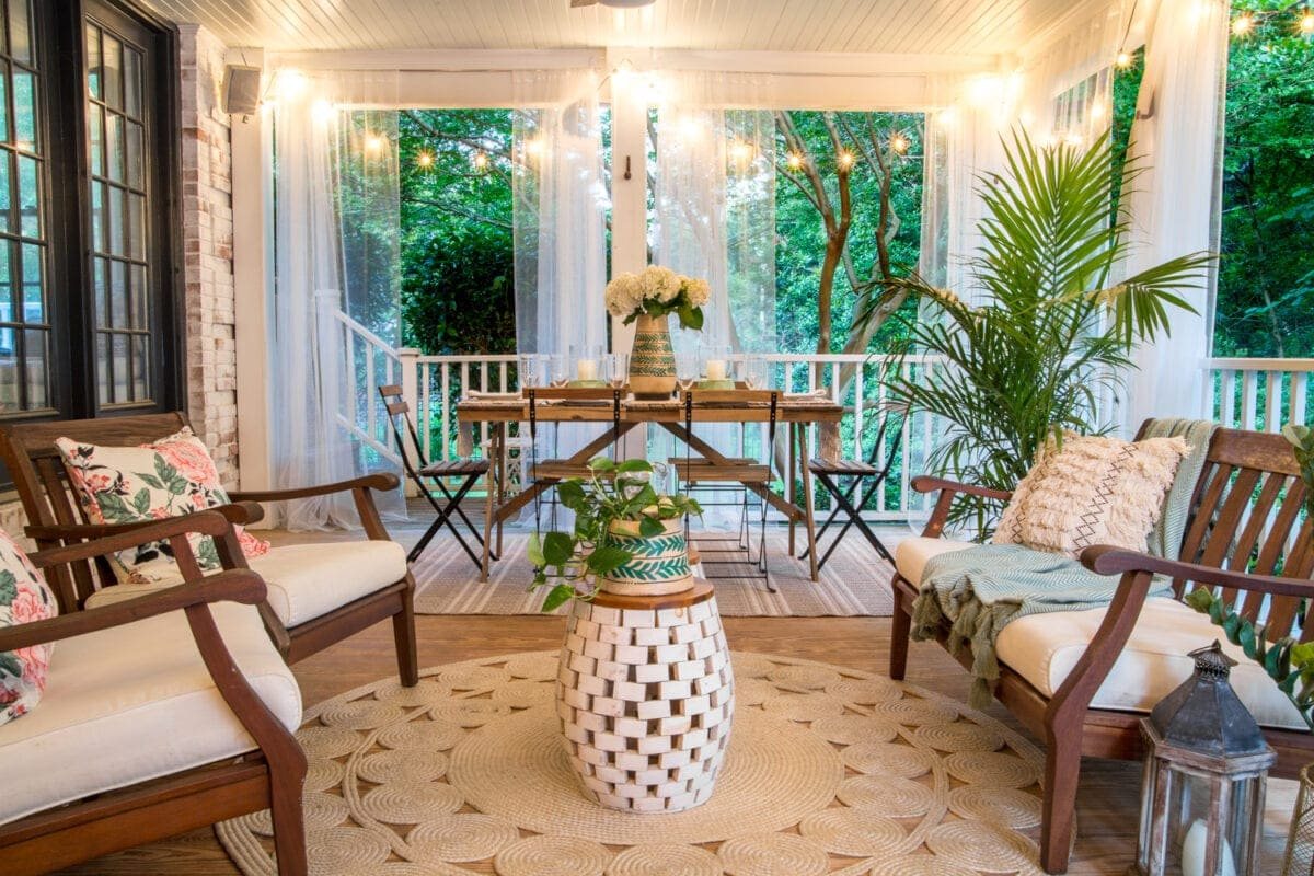 A tropical boho back porch decorated for summer with breezy, functional style from Walmart's Flower Home line by Drew Barrymore and string lights for evening ambience. #backporch #summerdecor