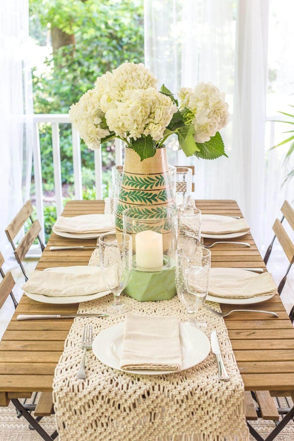 A tropical boho back porch decorated for summer with breezy, functional style from Walmart's Flower Home line by Drew Barrymore and string lights for evening ambience. #backporch #summerdecor