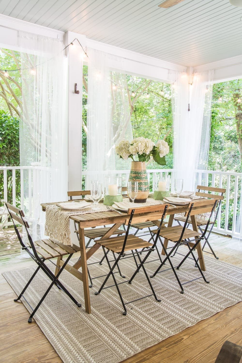 A tropical boho back porch decorated for summer with breezy, functional style from Walmart's Flower Home line by Drew Barrymore and string lights for evening ambience. #backporch #summerdecor