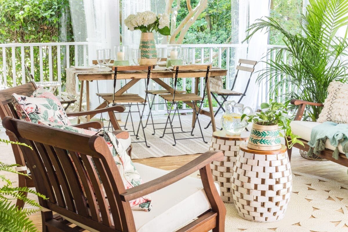 A tropical boho back porch decorated for summer with breezy, functional style from Walmart's Flower Home line by Drew Barrymore and string lights for evening ambience. #backporch #summerdecor