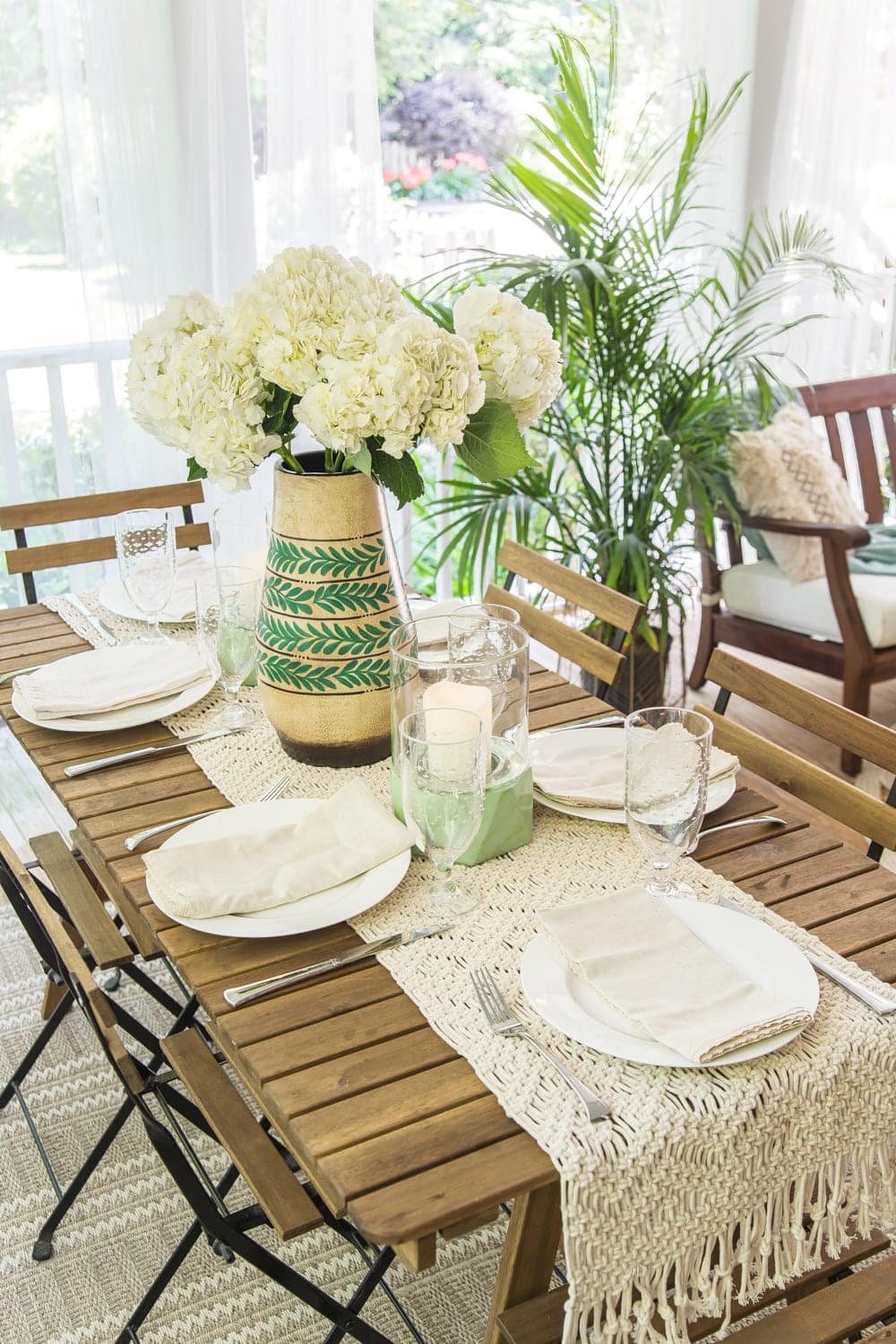 A tropical boho back porch decorated for summer with breezy, functional style from Walmart's Flower Home line by Drew Barrymore and string lights for evening ambience. #backporch #summerdecor