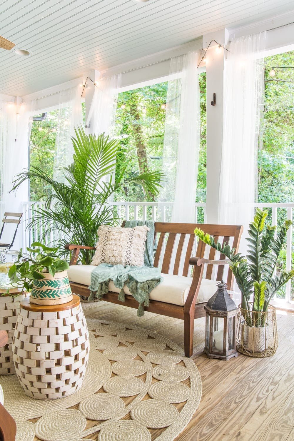 A tropical boho back porch decorated for summer with breezy, functional style from Walmart's Flower Home line by Drew Barrymore and string lights for evening ambience. #backporch #summerdecor