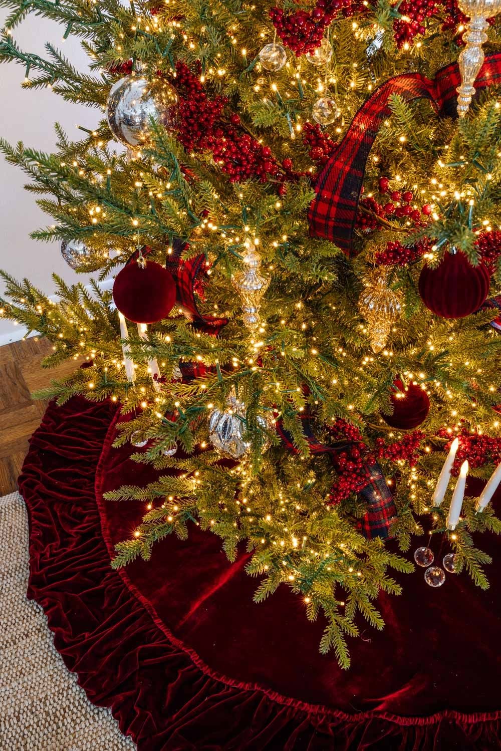 Ralph Lauren Christmas tree decorating ideas on a budget - red velvet tree skirt and red berry garland with mercury glass ornaments