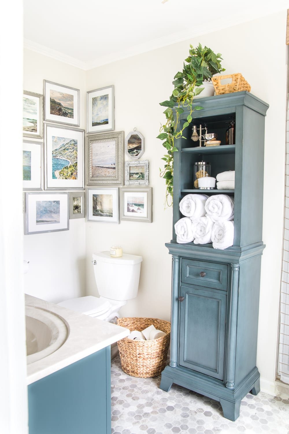 Budget Master Bathroom Refresh Reveal | corner gallery wall with thrifted frames and free coastal art printables and linen cabinet