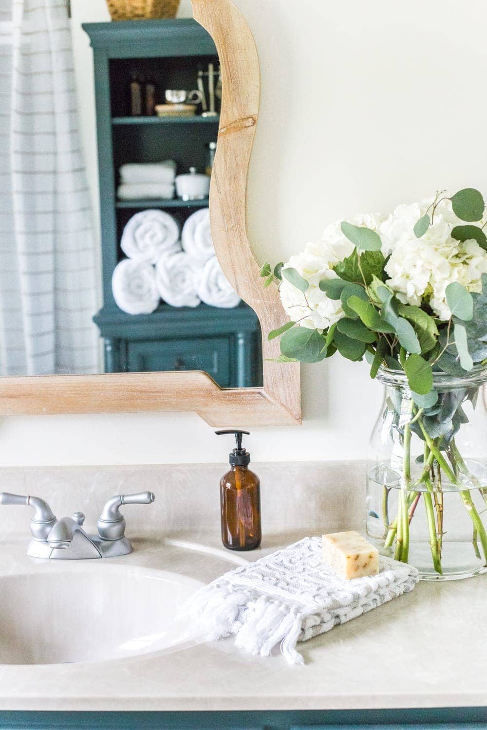 Budget Master Bathroom Refresh Reveal | Vinyl hexagon tile floor, wooden arch mirrors, and DIY painted vanity