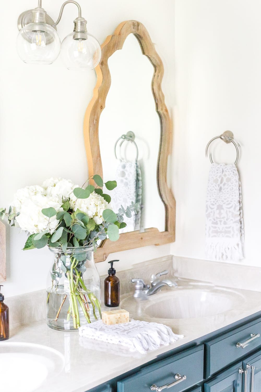 Budget Master Bathroom Refresh Reveal | Vinyl hexagon tile floor, wooden arch mirrors, and DIY painted vanity