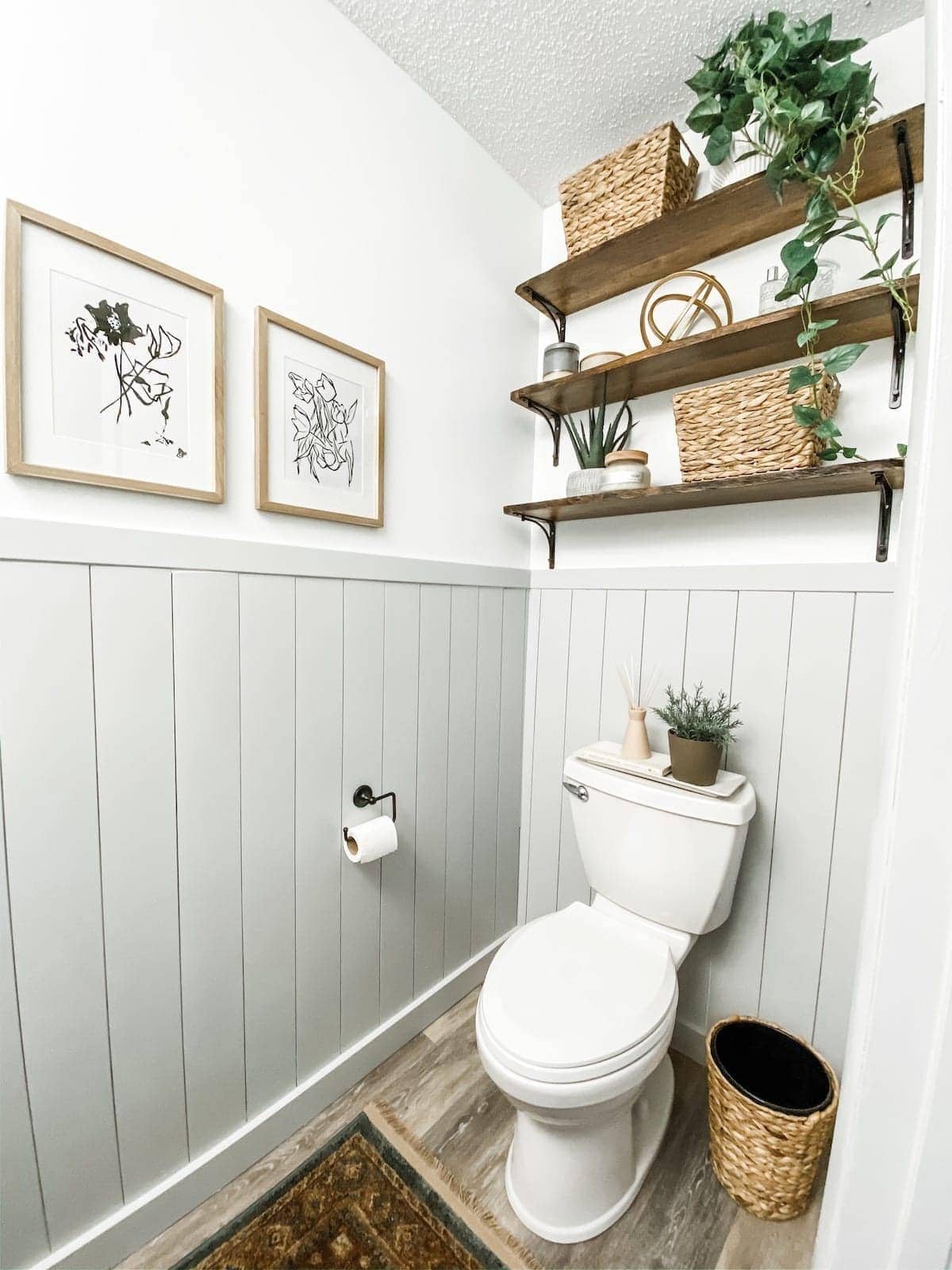 bathroom shelving above toilet with plants and decor