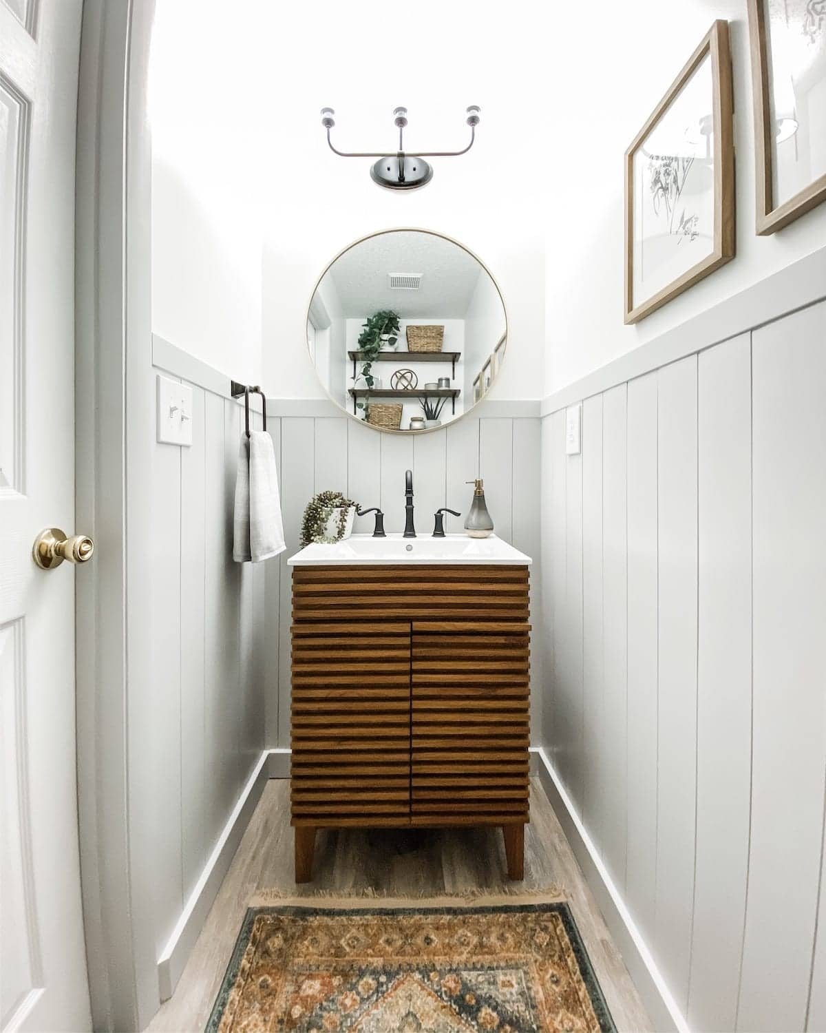 small powder room with vertical shiplap and Mid Century Modern style vanity