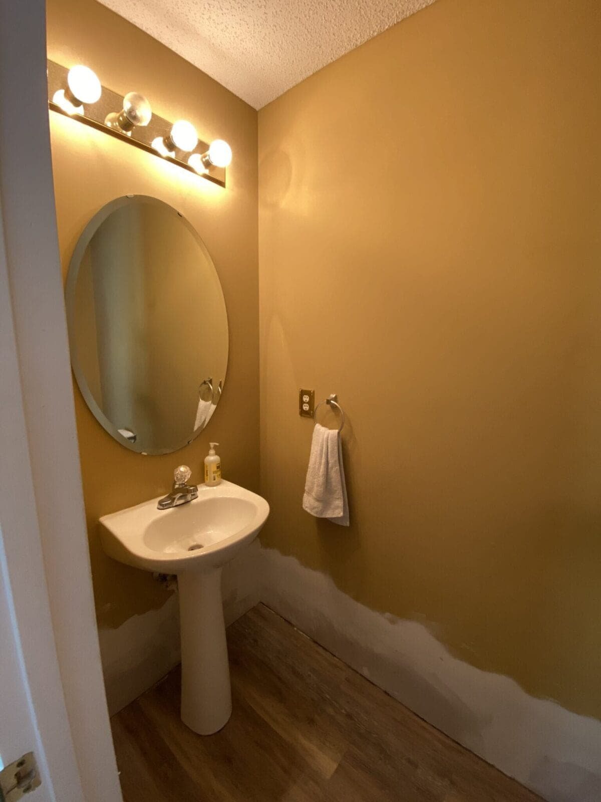 before powder room with gold walls