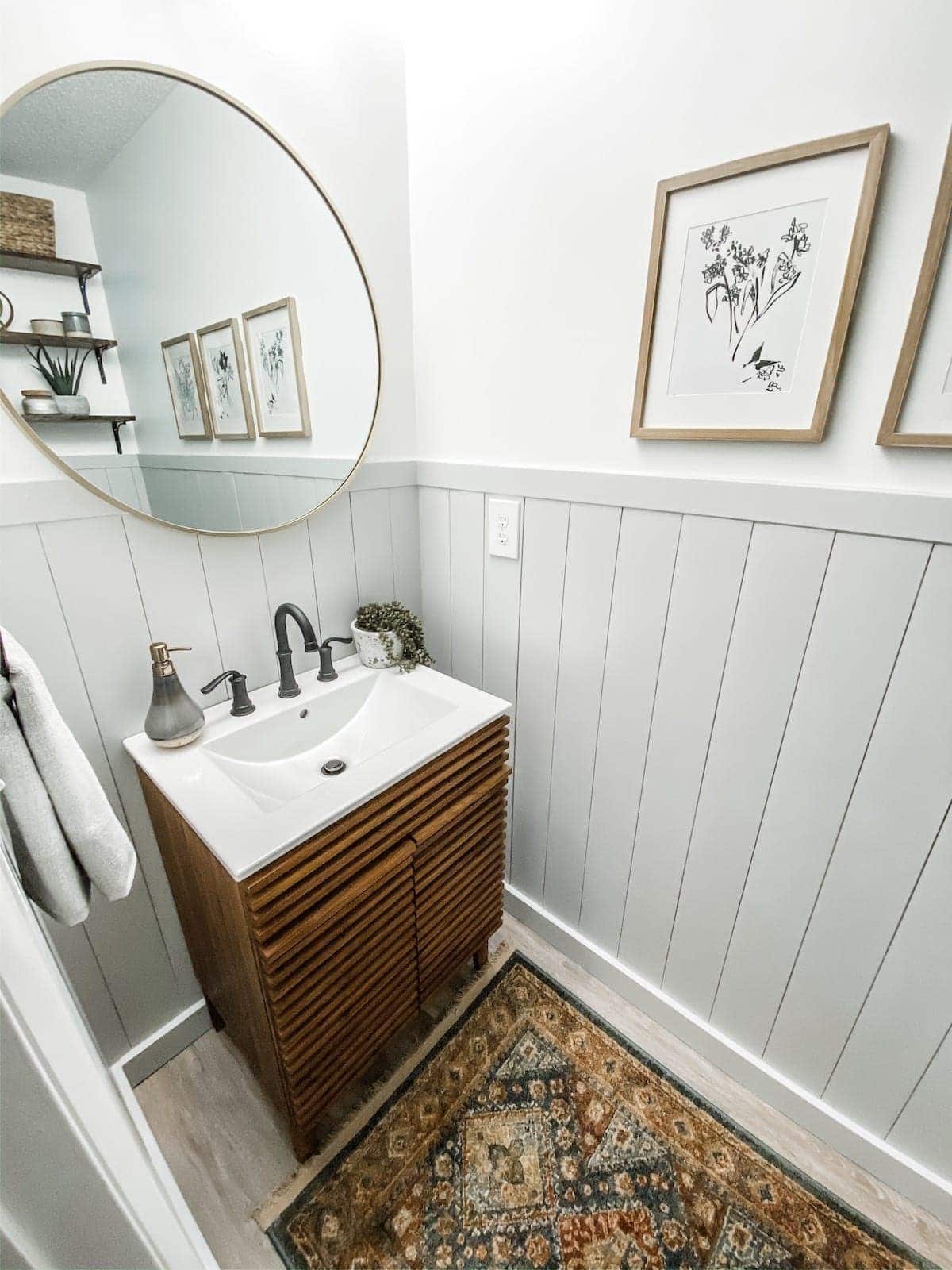 powder room with gray vertical shiplap and white walls