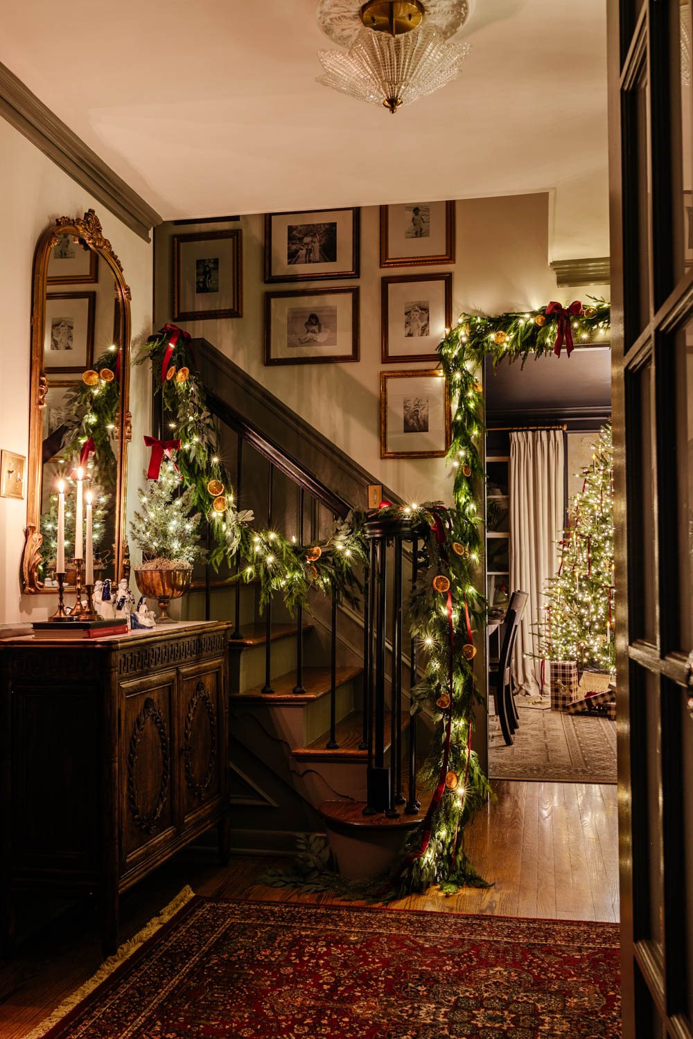 traditional candlelight Christmas night tour in entryway with nativity