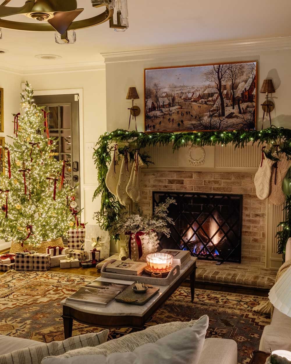 candlelight Christmas tour in living room with tree and traditional fireplace