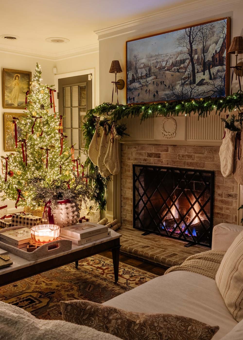 candlelight Christmas tour in living room with tree and traditional fireplace