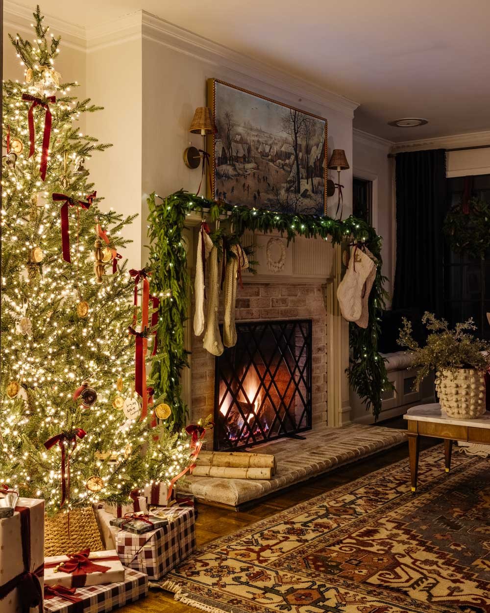 candlelight Christmas tour in living room with tree and traditional fireplace