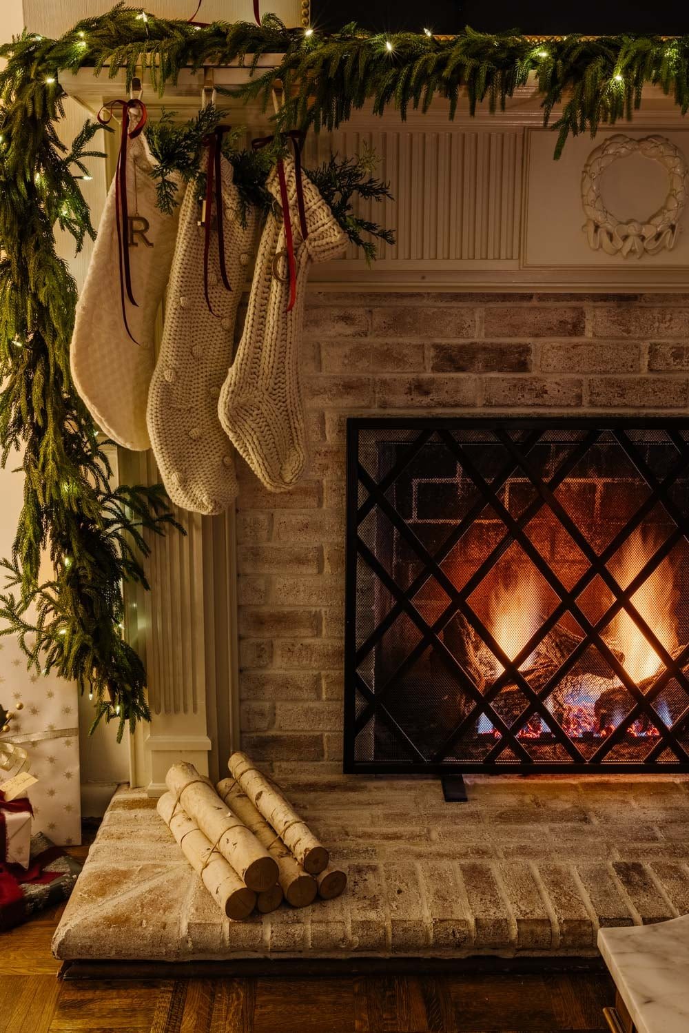 candlelight Christmas tour in living room with tree and traditional fireplace