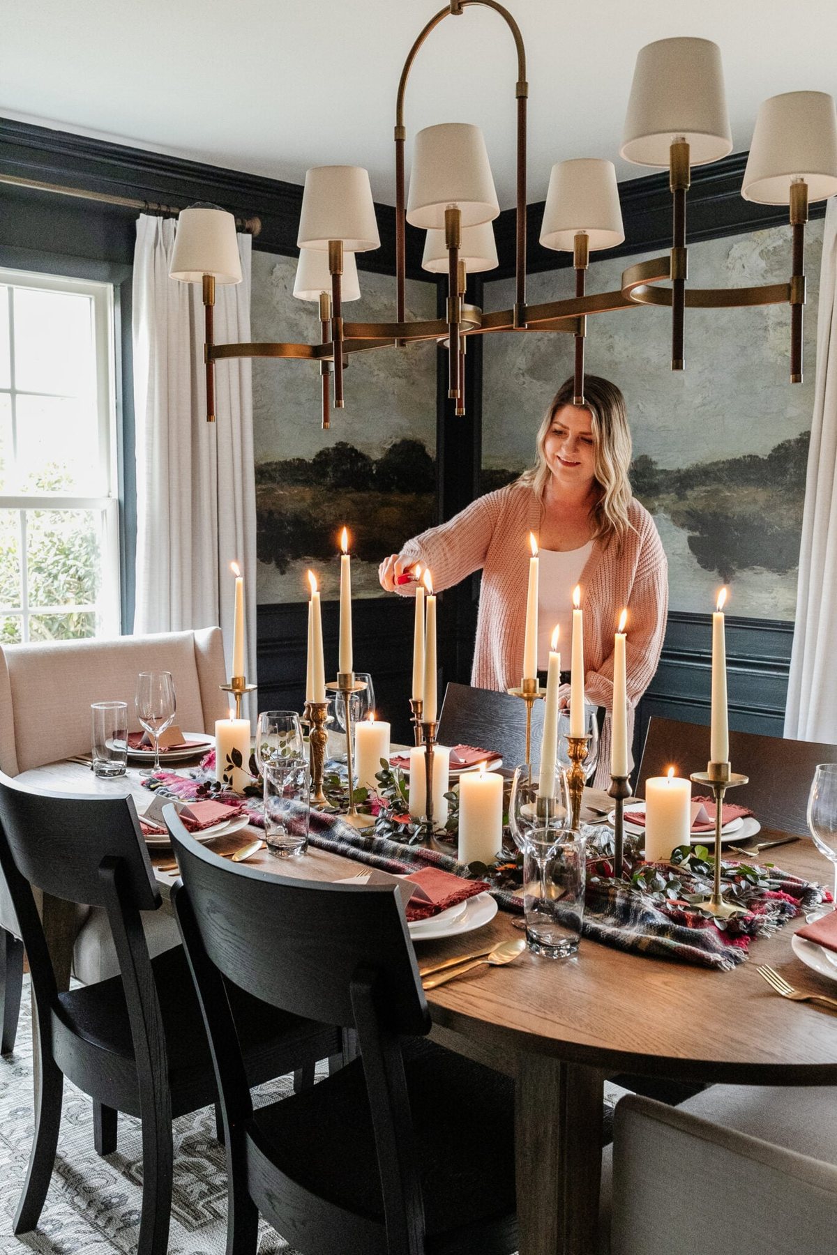 lighting candles on a set Thanksgiving table