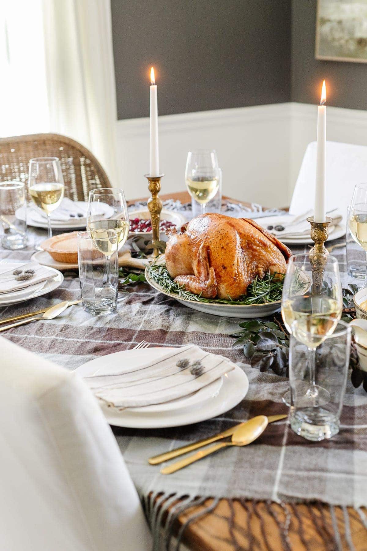 cheap Thanksgiving table decor with a throw blanket repurposed as a tablecloth