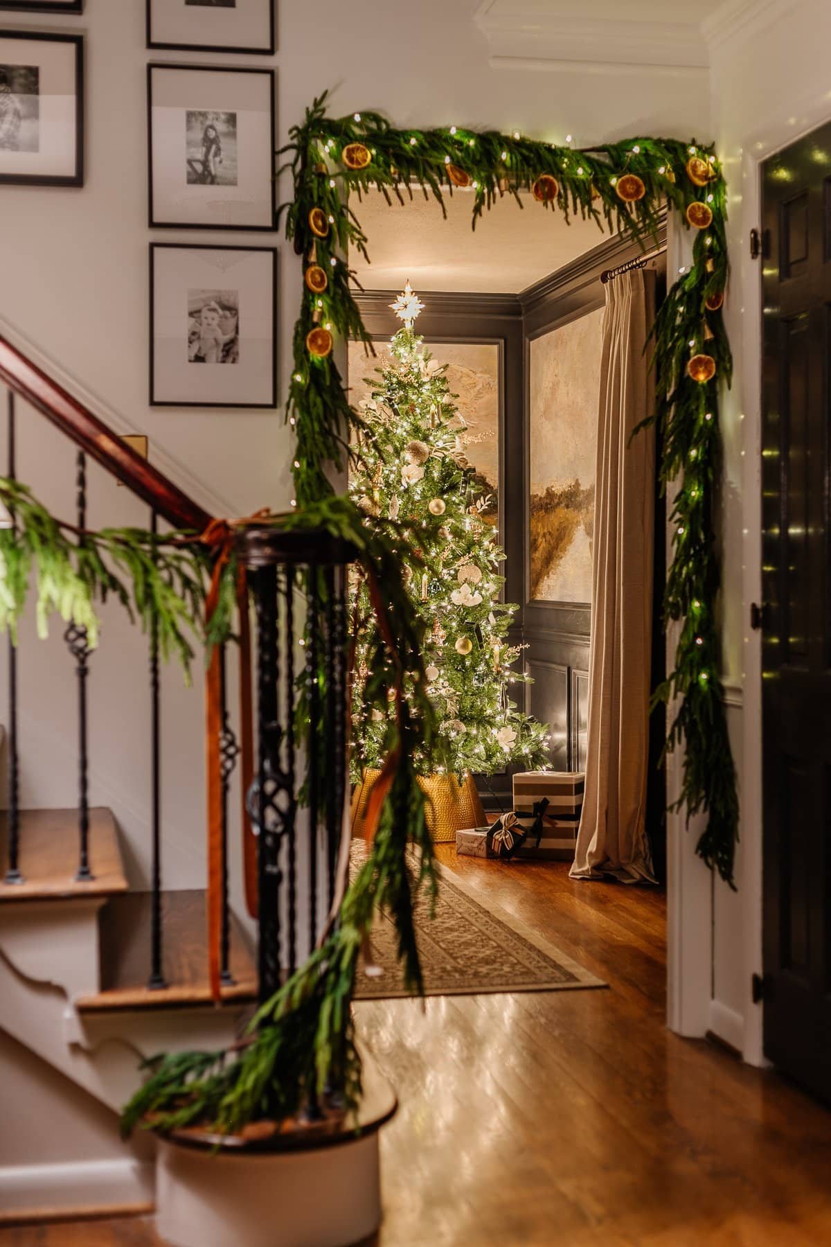 Christmas candlelight in foyer looking into dining room tree