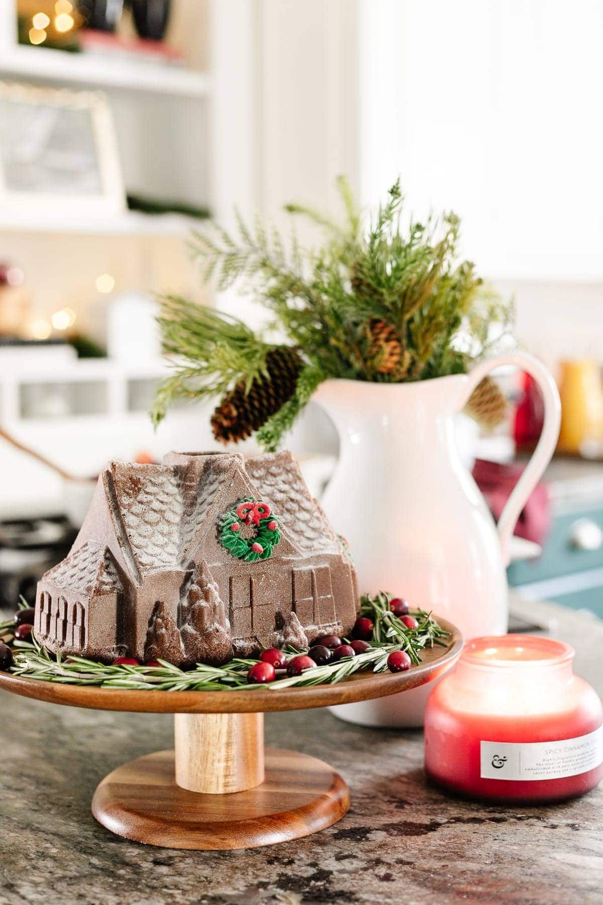Christmas brunch decor with a gingerbread house on a cake stand