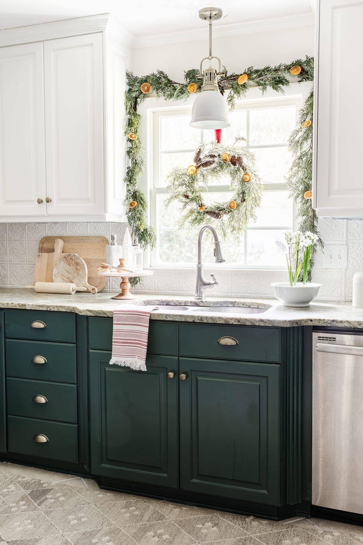 Christmas kitchen window decorated with garland and wreath