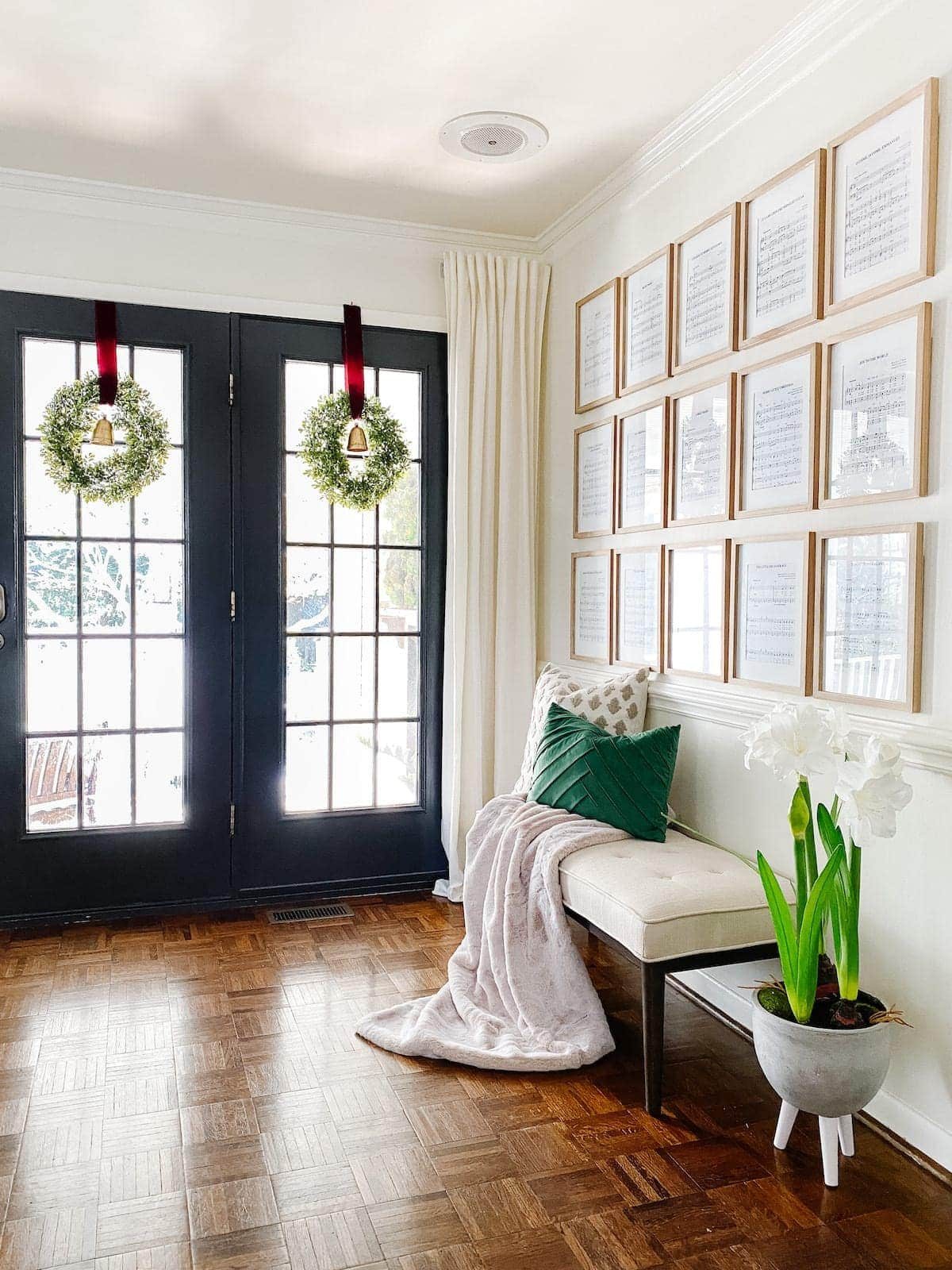 wreaths on windows and entryway with Christmas wall decor using sheet music art