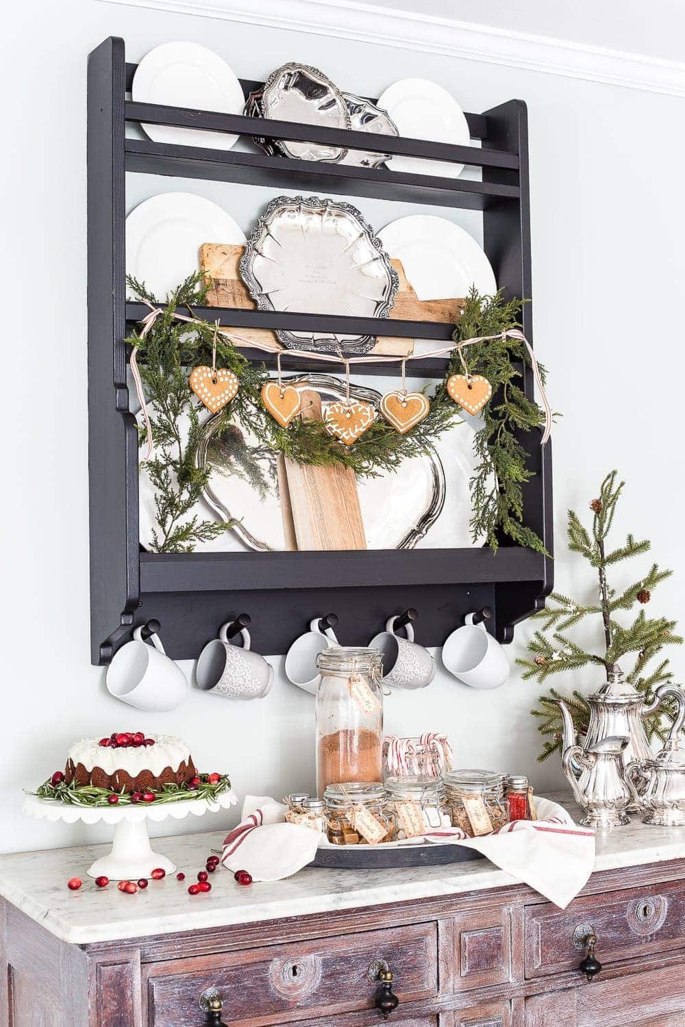 plate rack with garland and gingerbread cookies displayed Scandinavian style for Christmas