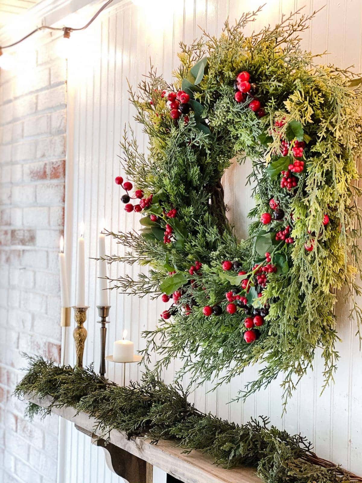 Christmas wreath as wall decor above a fireplace mantel