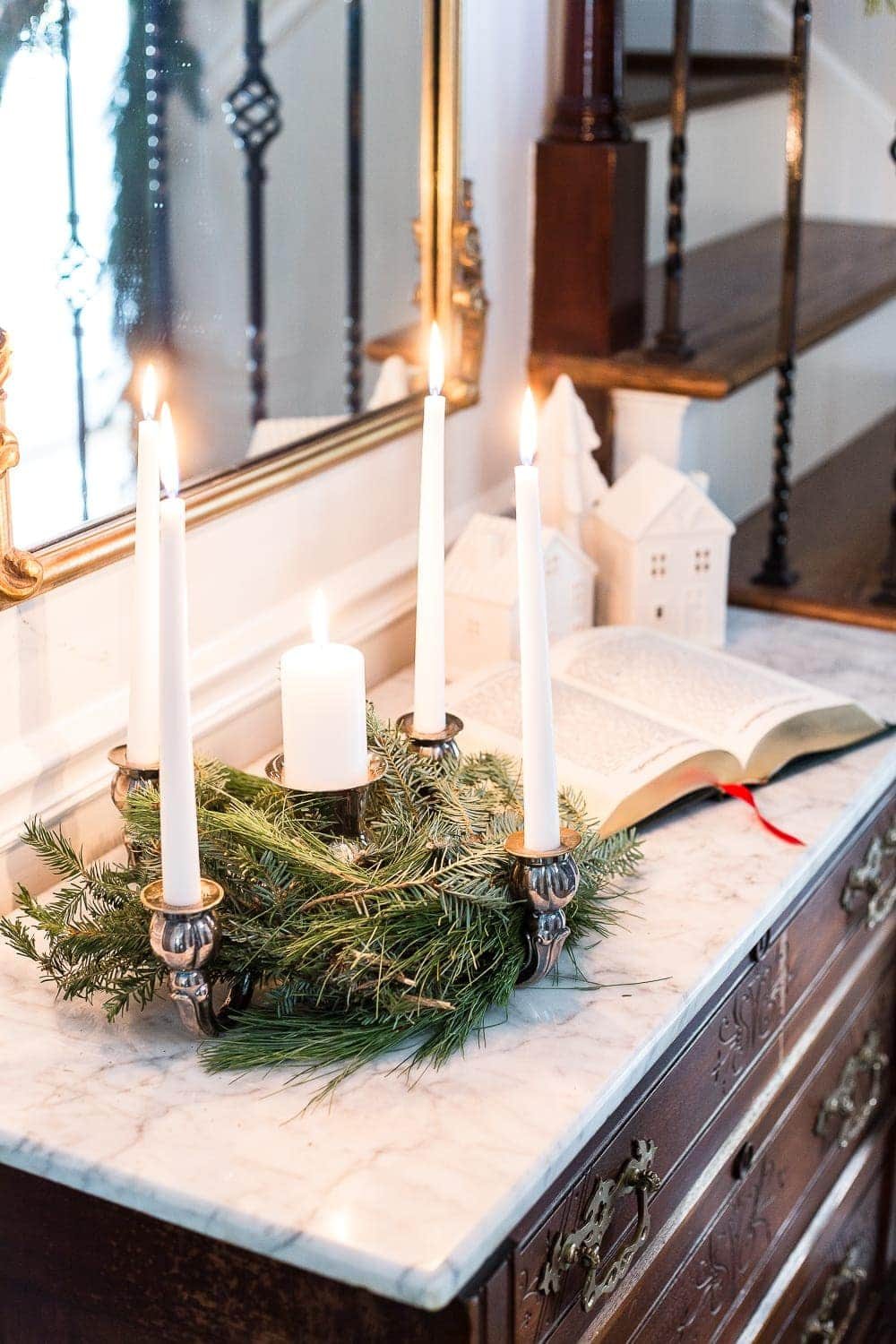 Classic Christmas Foyer | unigumushane.com - A classic traditional entryway / foyer decorated for Christmas using fresh pine and holly greenery and a St. Lucia Day Advent wreath. #christmasfoyer #classicdecor #traditionalchristmas