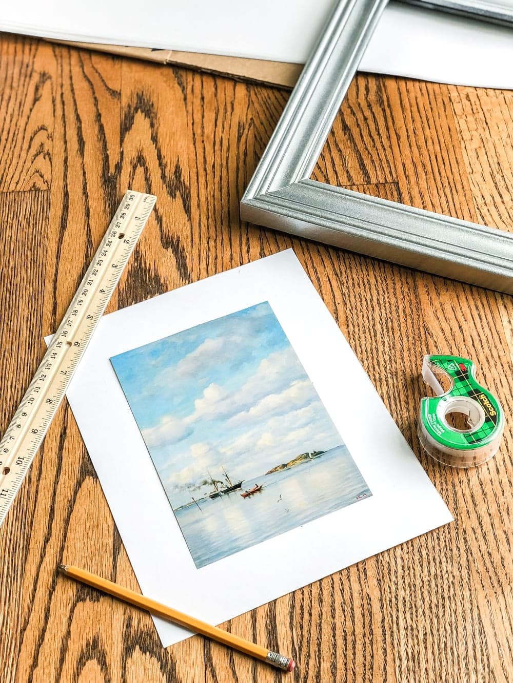 A free printable set of a coastal gallery wall featuring antique ocean paintings and how to frame them inexpensively with thrifted finds. #coastaldecor #gallerywall #bathroomart #bathroomwall #bathroomdecor #coastalart