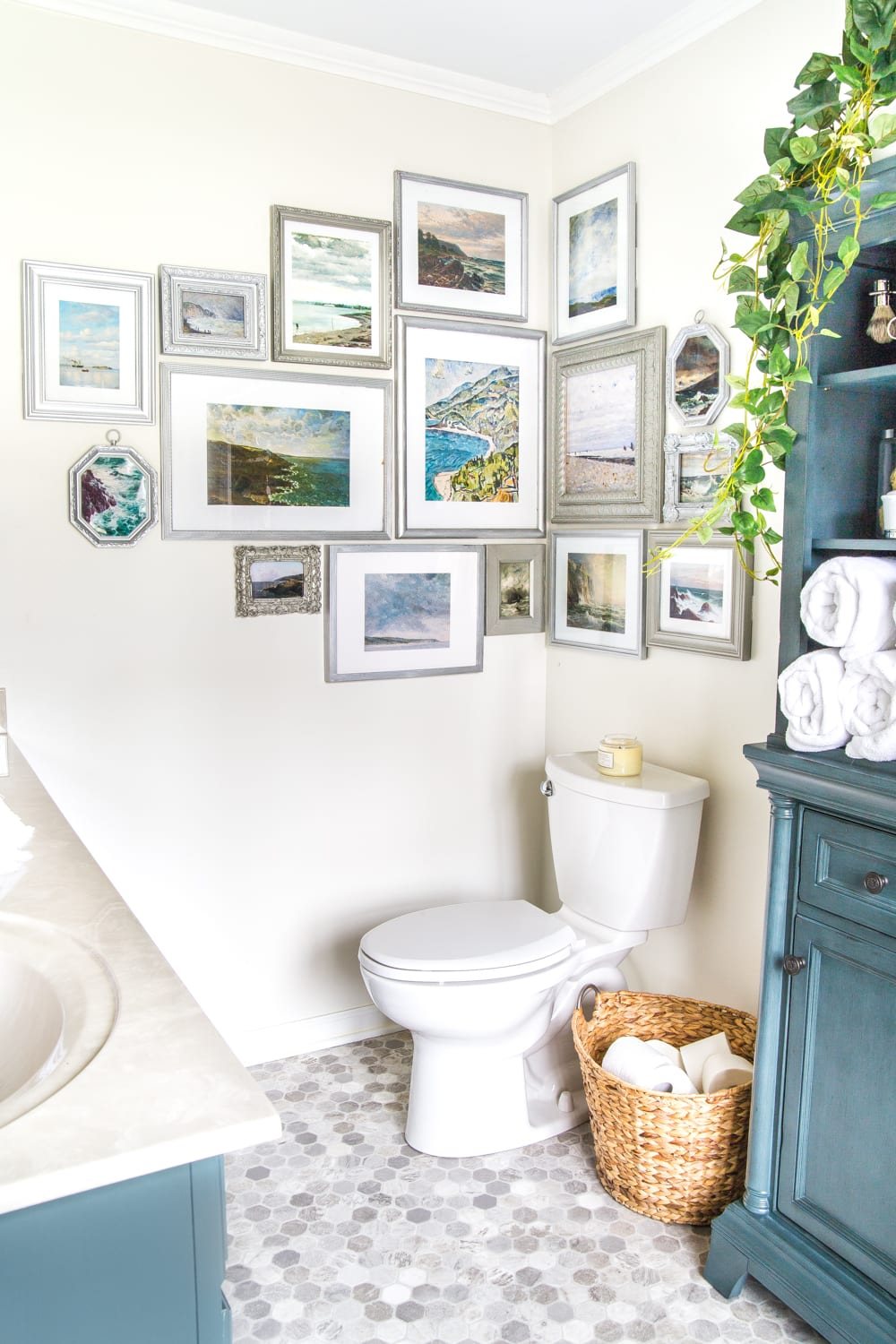 A free printable set of a coastal gallery wall featuring antique ocean paintings and how to frame them inexpensively with thrifted finds. #coastaldecor #gallerywall #bathroomart #bathroomwall #bathroomdecor #coastalart