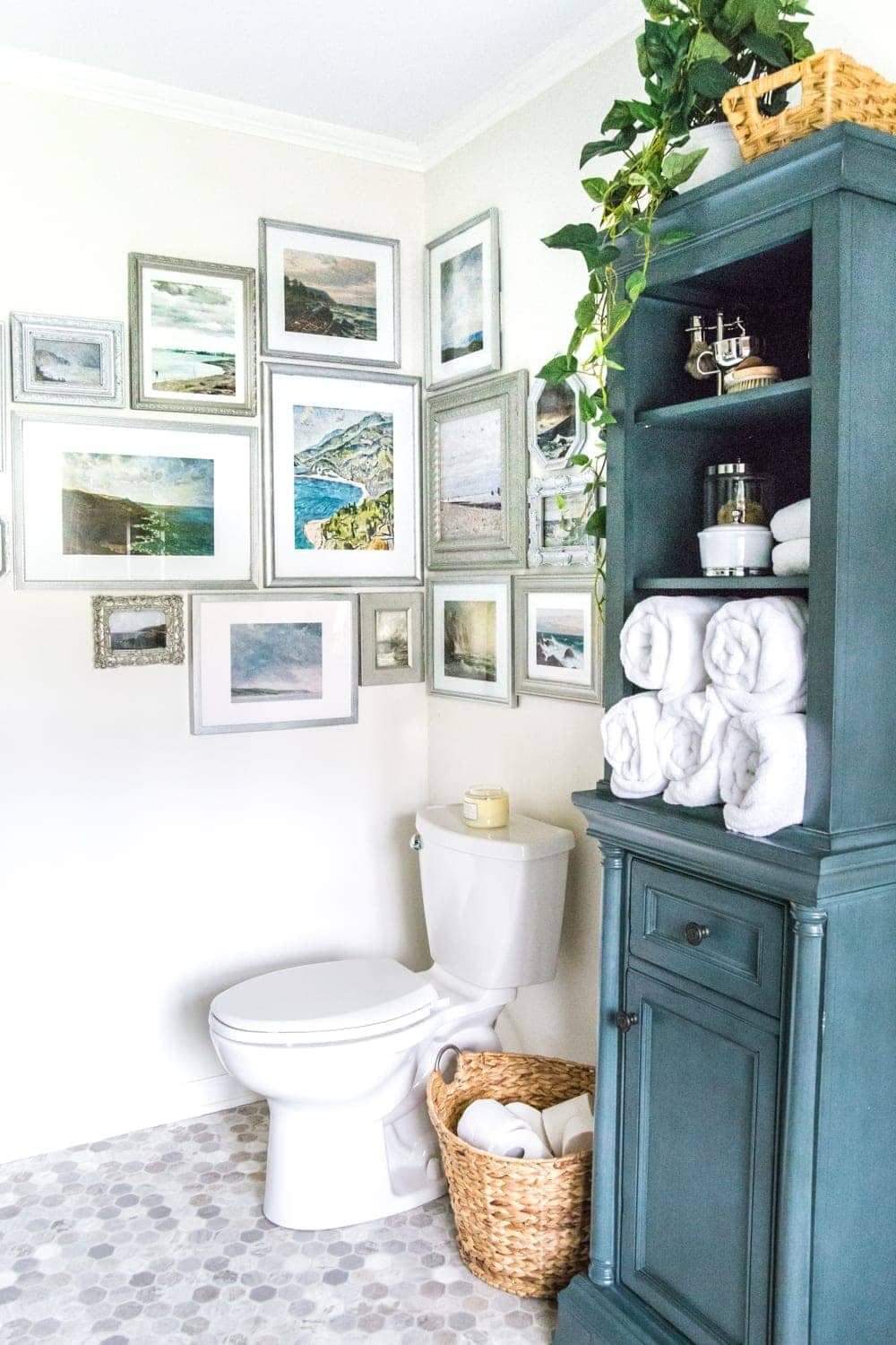 A free printable set of a coastal gallery wall featuring antique ocean paintings and how to frame them inexpensively with thrifted finds. #coastaldecor #gallerywall #bathroomart #bathroomwall #bathroomdecor #coastalart