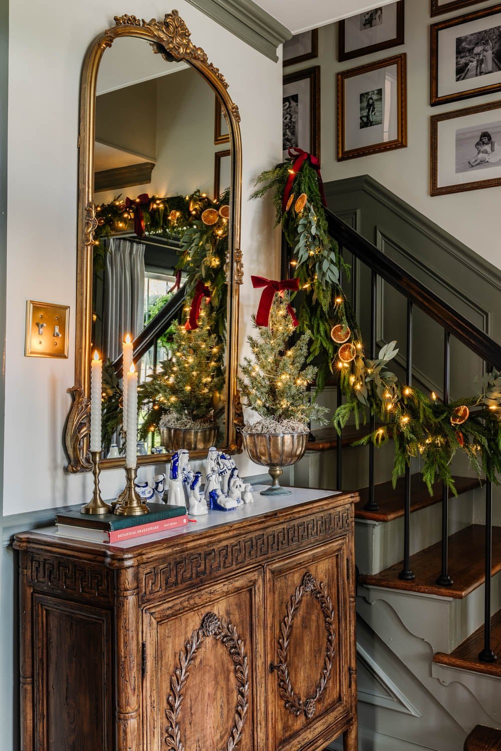 entryway cabinet with blue and white nativity set and candles decorated for Christmas