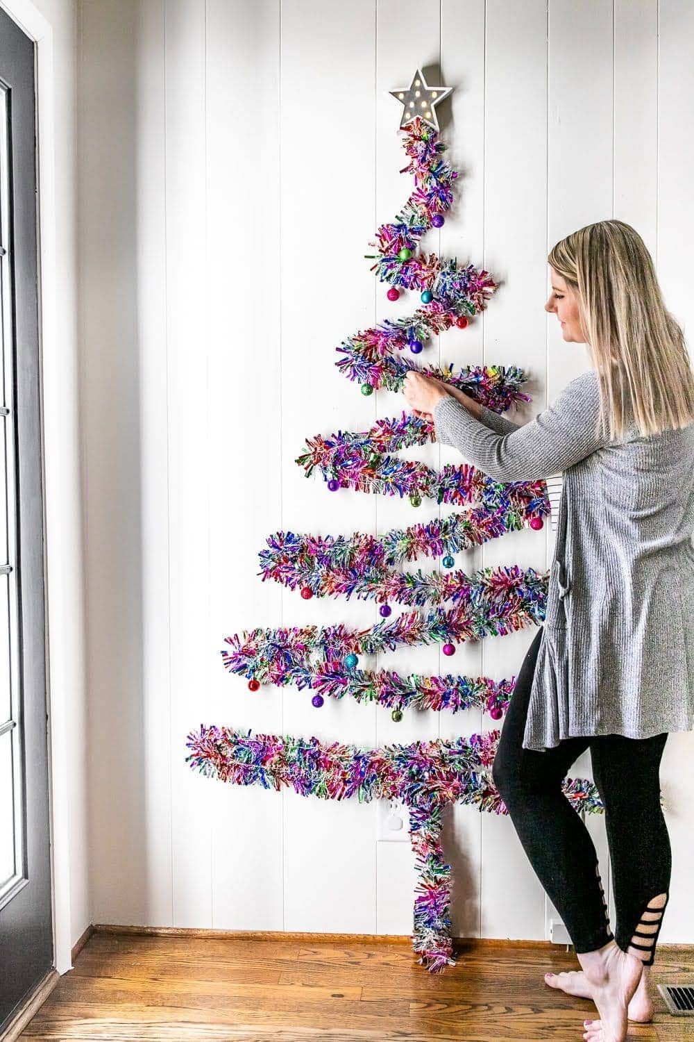 Adding ornaments to a wall Christmas tree