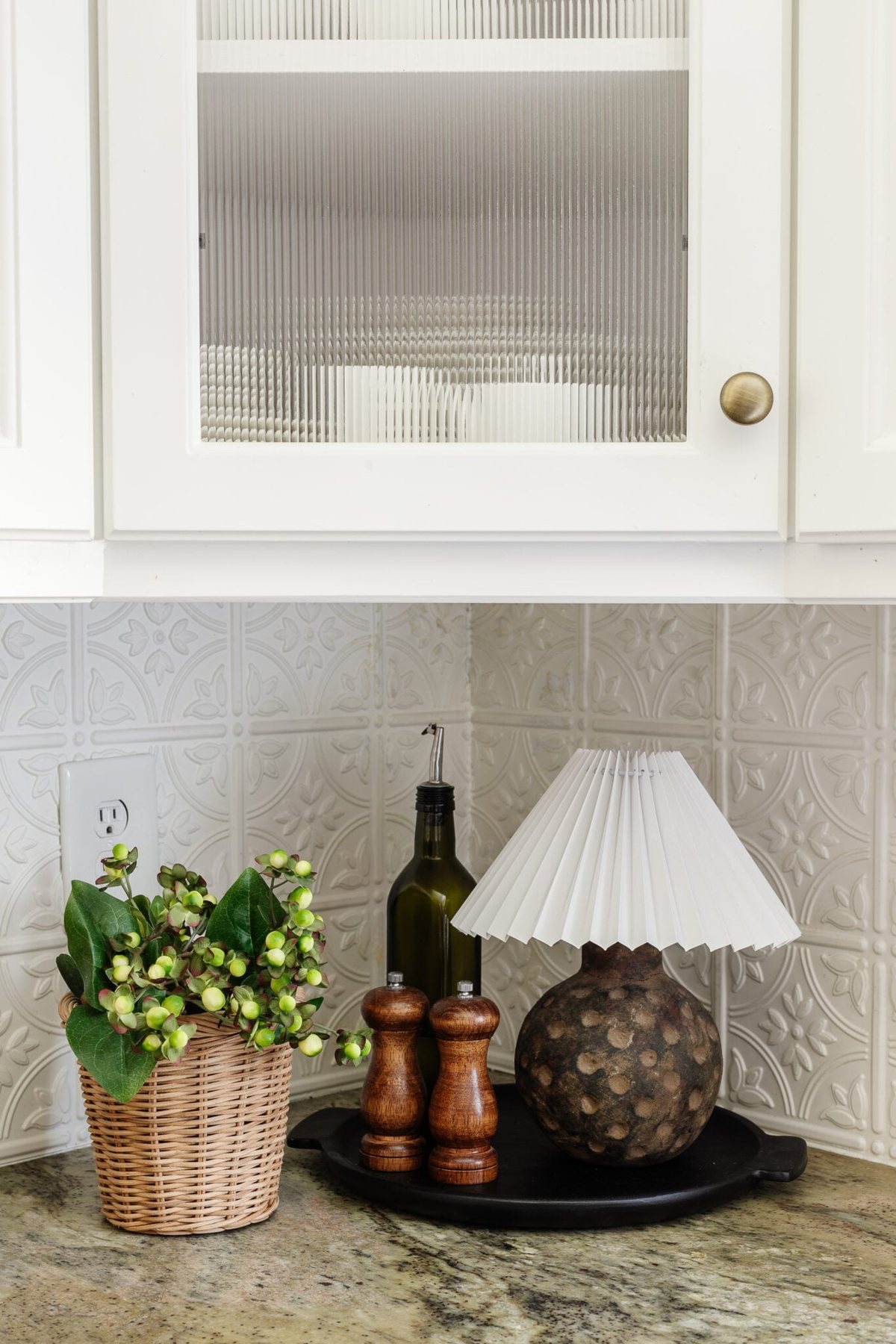 placing a pleated lamp shade on top of a terracotta vase