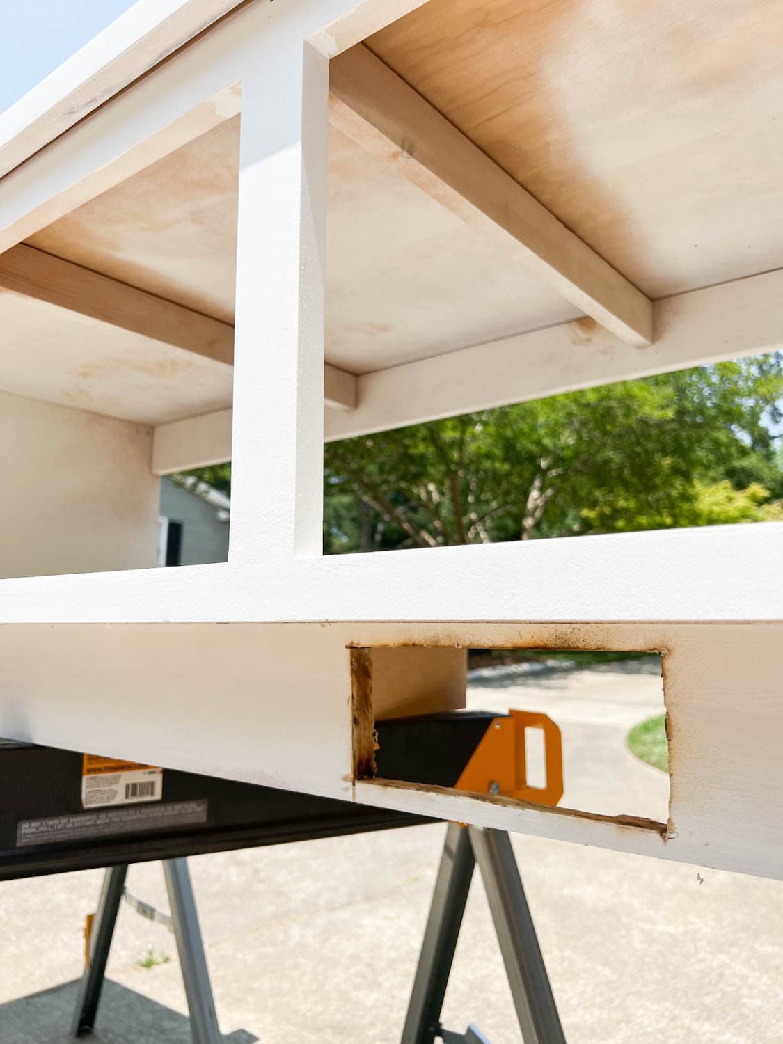 hole cut for an air vent redirect under a banquette bench